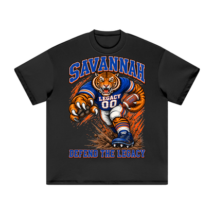 Front view of the black Savannah State Defend Tee with a football tiger graphic and Defend the Legacy lettering in royal blue and orange.