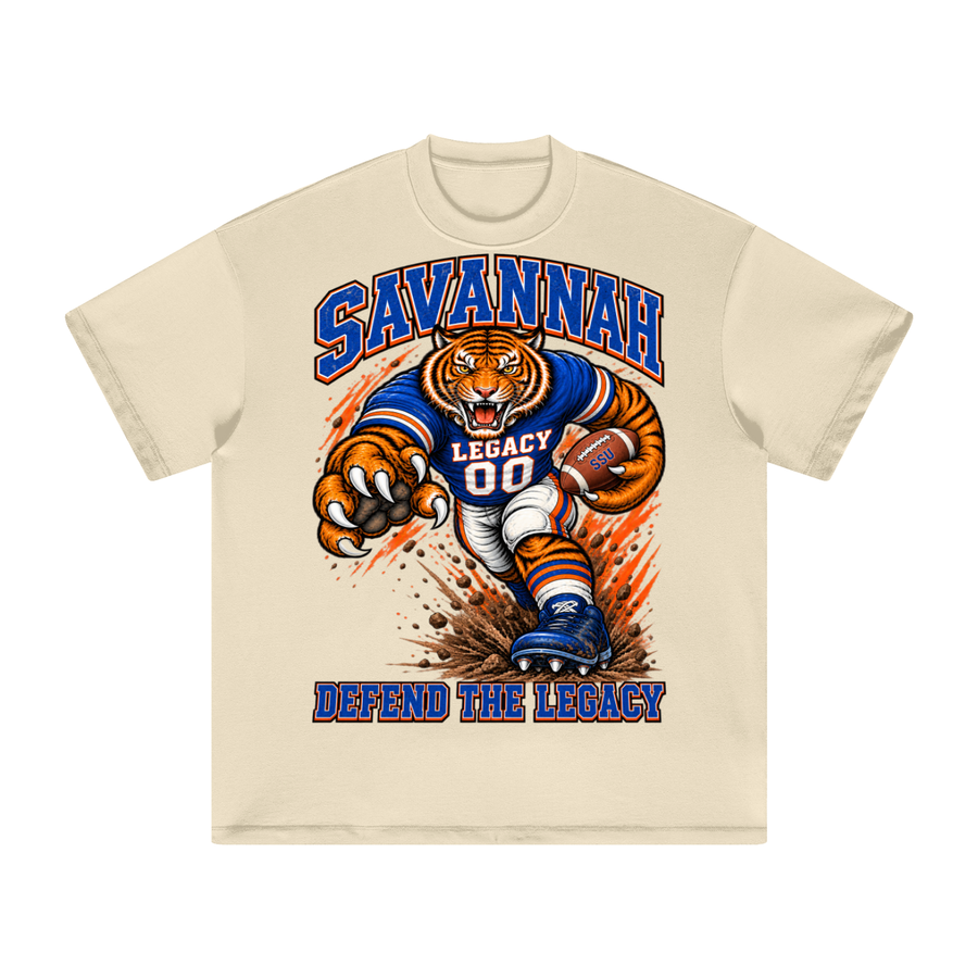 Front view of the cream Savannah State Defend Tee with a football tiger graphic and Defend the Legacy lettering in royal blue and orange.
