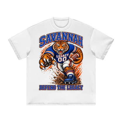 Front view of the white Savannah State Defend Tee with a football tiger graphic and Defend the Legacy lettering in royal blue and orange.