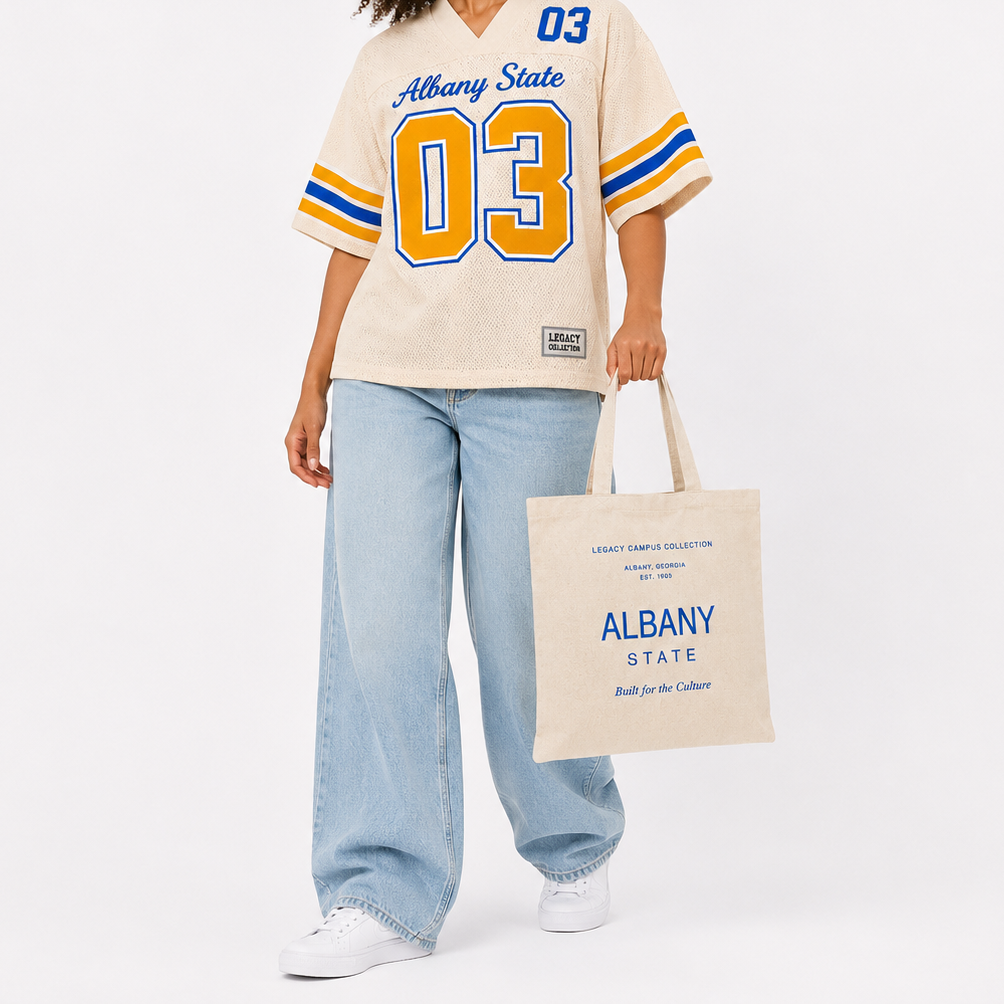 Albany State Legacy Jersey cropped female campaign image in cream jersey with Albany State tote