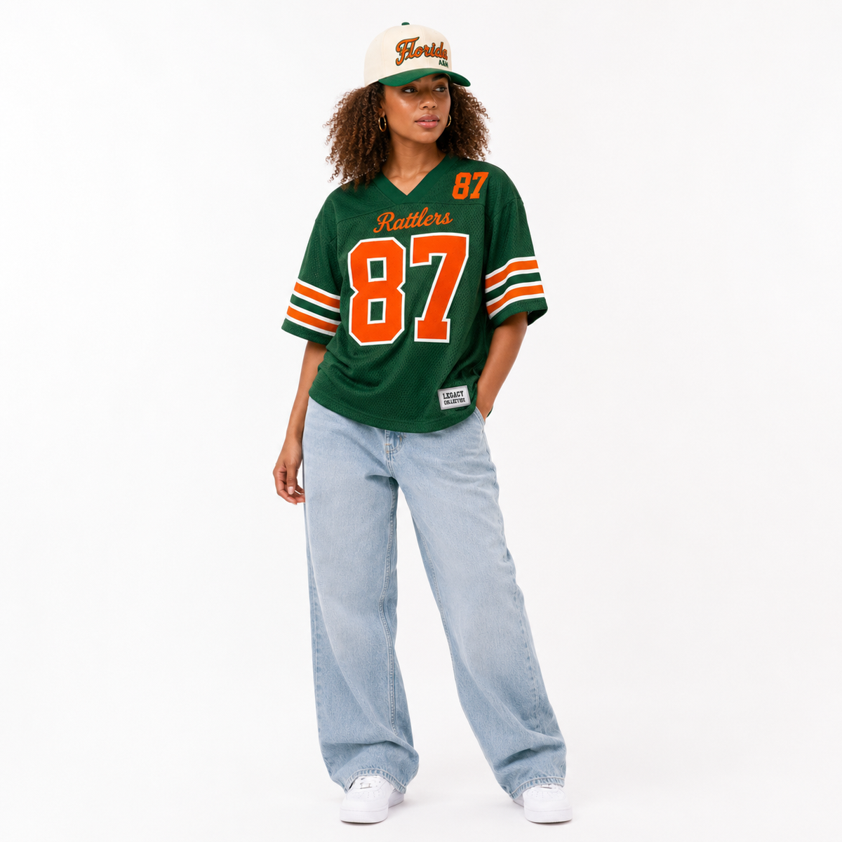 FAMU Legacy Jersey female campaign image in primary green jersey with FAMU cap