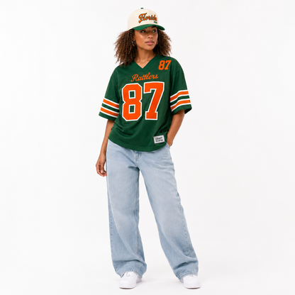 FAMU Legacy Jersey female campaign image in primary green jersey with FAMU cap