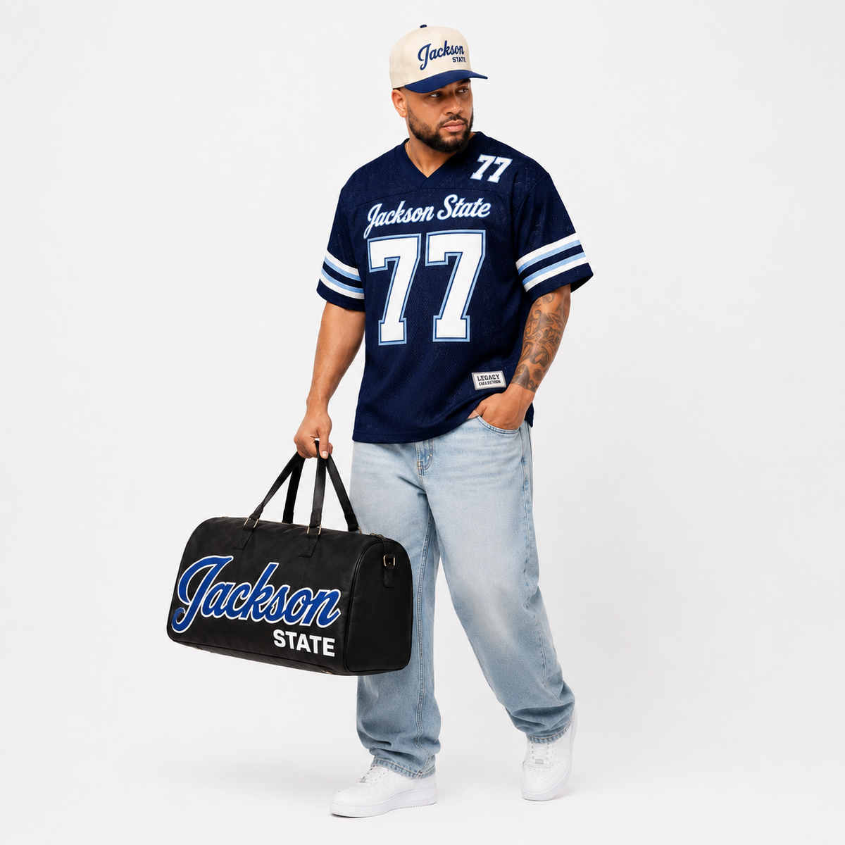 Jackson State Legacy Campus Collection male campaign model in navy jersey with cap and travel bag