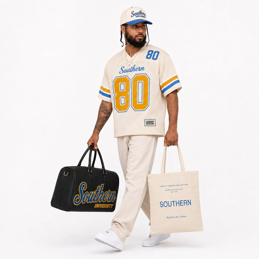 Southern Legacy Campus Collection male campaign model with Southern travel bag and tote alternate view