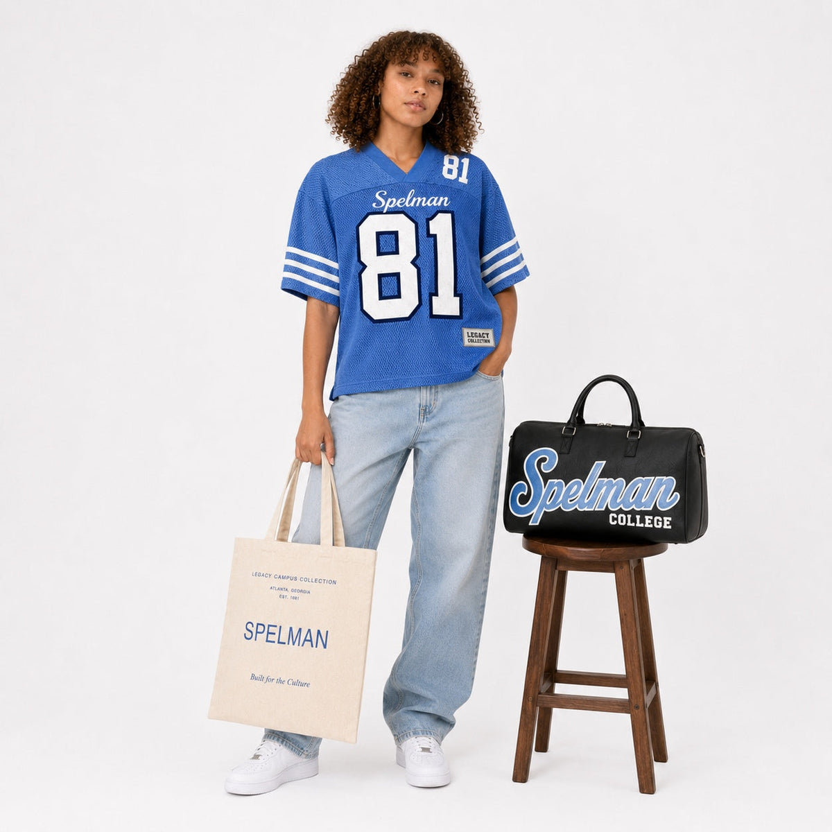 Spelman Legacy Campus Collection female campaign model with Spelman travel bag and tote
